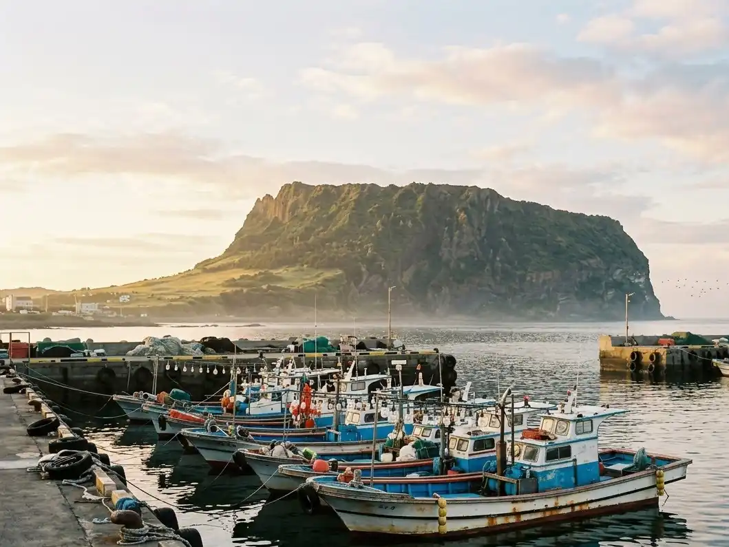Small boats in Seongsan harbor with the crater behind