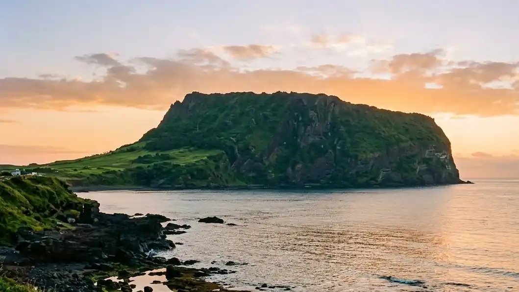 Seongsan Ilchulbong crater rising from the sea at sunrise on Jeju Island