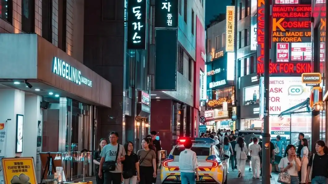 Neon signs and crowds on a Myeongdong street at night