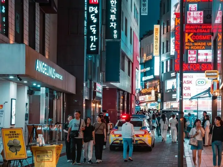 Neon signs and crowds on a Myeongdong street at night