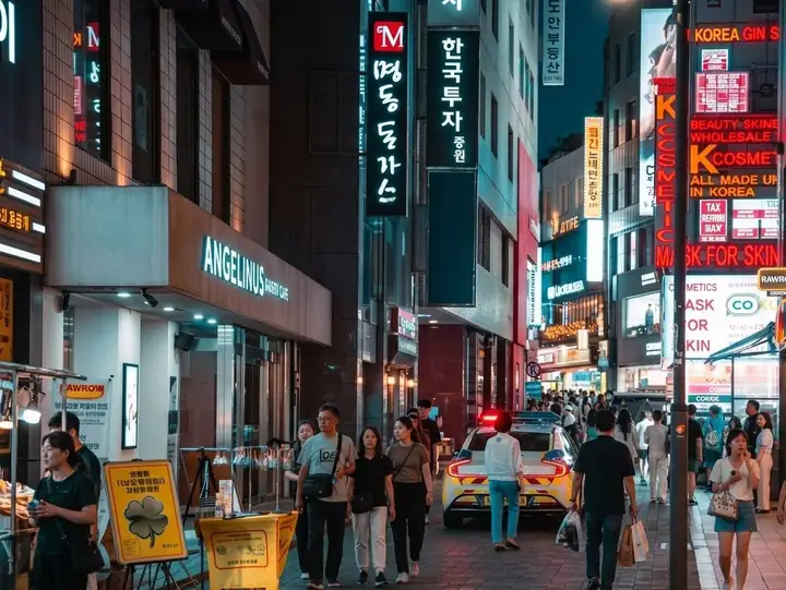 Neon signs and crowds on a Myeongdong street at night